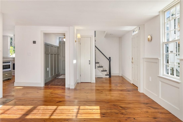 spare room with light hardwood / wood-style floors and plenty of natural light