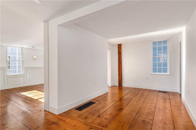 unfurnished room with wood-type flooring