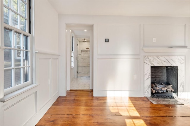 unfurnished living room with a fireplace and hardwood / wood-style flooring