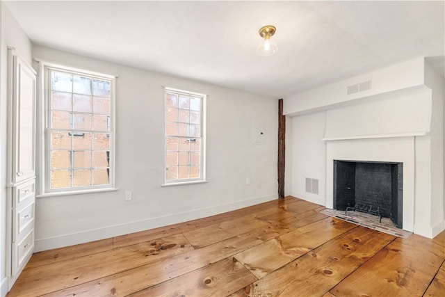 unfurnished living room featuring light hardwood / wood-style floors