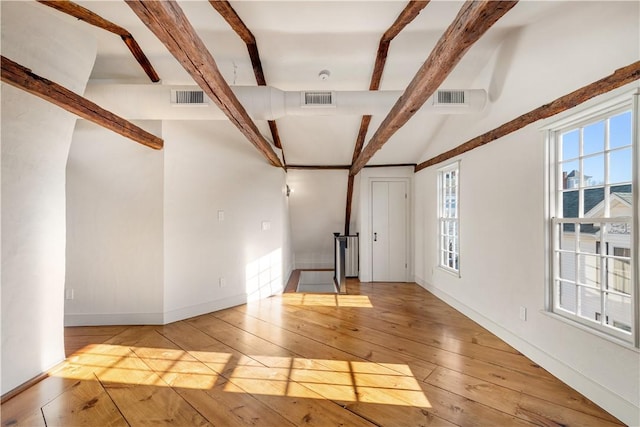 interior space featuring vaulted ceiling with beams and light hardwood / wood-style floors