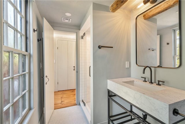 bathroom featuring a shower, tile patterned flooring, and vanity