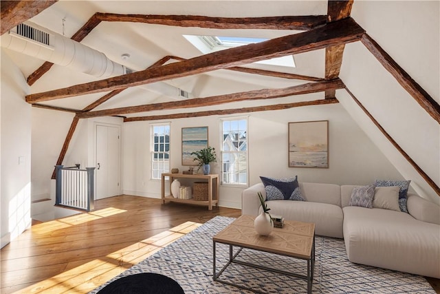 living room featuring hardwood / wood-style flooring and vaulted ceiling with beams