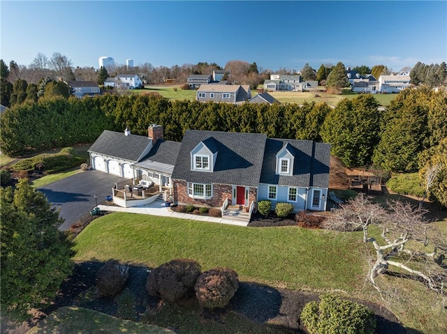 view of front of property featuring a garage and a front lawn