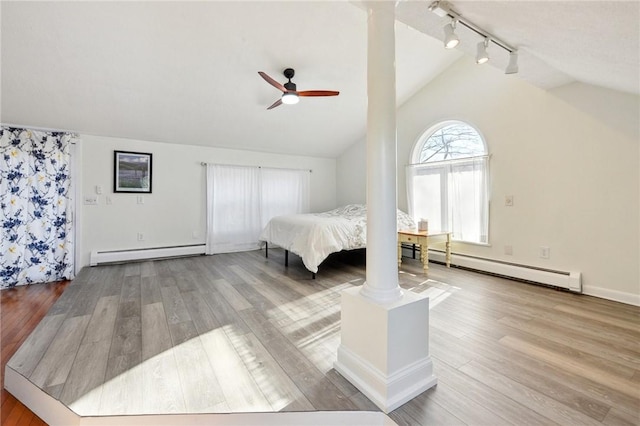 bedroom featuring wood-type flooring, vaulted ceiling, ceiling fan, and a baseboard heating unit