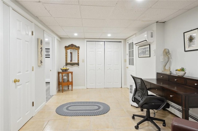 office area featuring a drop ceiling, light tile patterned flooring, and a wall unit AC