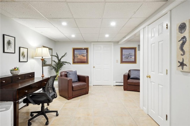 tiled home office featuring a paneled ceiling and a baseboard heating unit