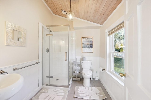 bathroom featuring a shower with door, wooden ceiling, sink, and ornamental molding