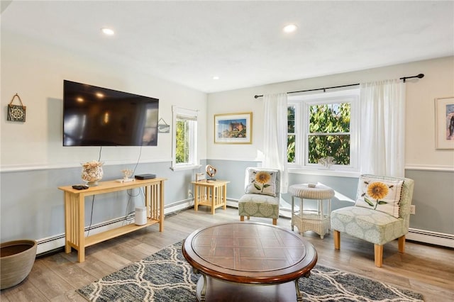 sitting room featuring hardwood / wood-style flooring and baseboard heating