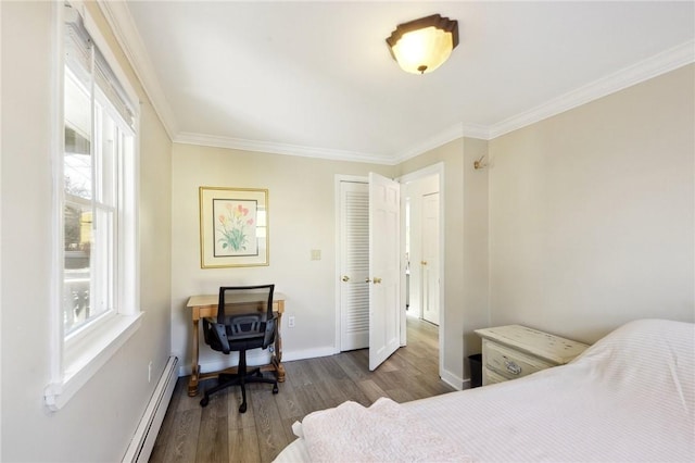 bedroom featuring hardwood / wood-style flooring, baseboard heating, and ornamental molding