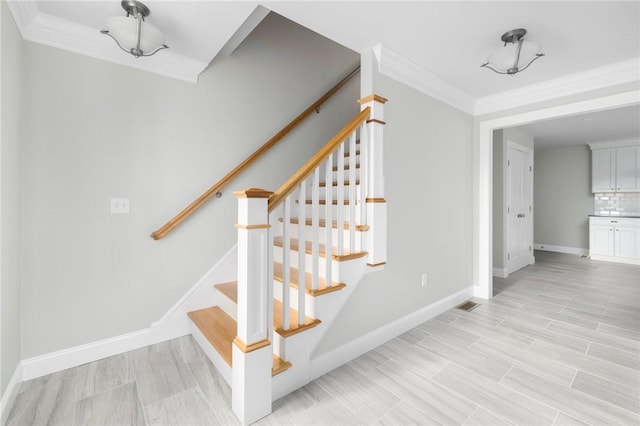 stairs with crown molding