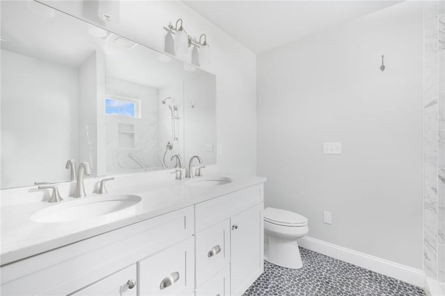 bathroom with a shower, vanity, and toilet