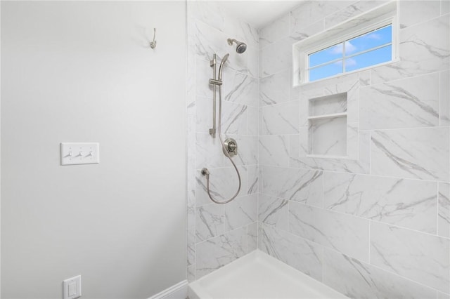 bathroom featuring a tile shower