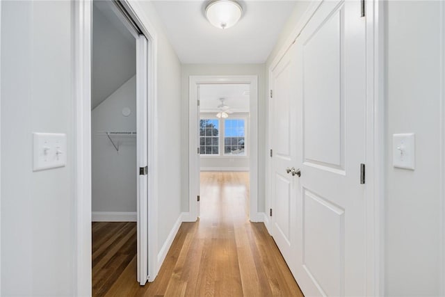 corridor with light hardwood / wood-style floors