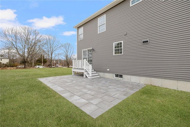 rear view of house featuring a patio area and a yard