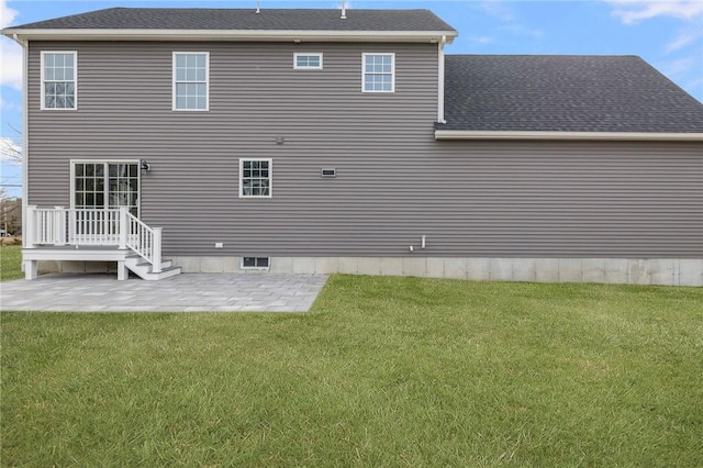 rear view of property featuring a yard and a patio