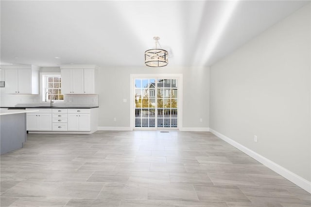 interior space with a wealth of natural light, sink, and a chandelier