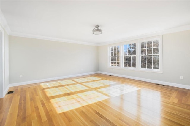 unfurnished room with light wood-type flooring and crown molding