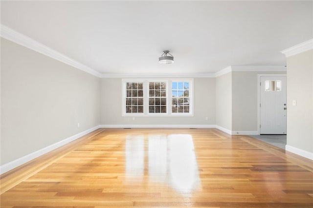 spare room featuring wood-type flooring and ornamental molding