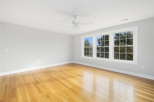 unfurnished room with ceiling fan and light hardwood / wood-style floors