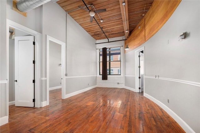 empty room with ceiling fan, wood ceiling, lofted ceiling, and hardwood / wood-style flooring