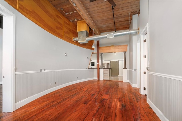 interior space featuring hardwood / wood-style flooring, wooden ceiling, and beamed ceiling