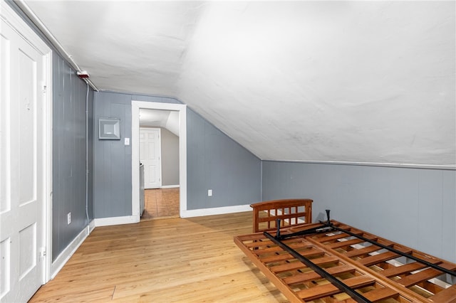 additional living space featuring light hardwood / wood-style floors and vaulted ceiling