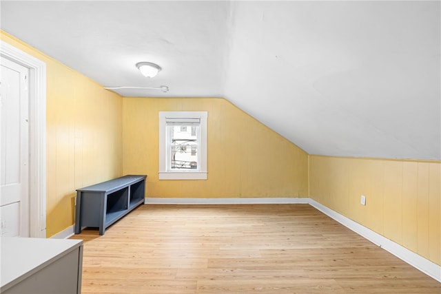 bonus room with light hardwood / wood-style flooring and vaulted ceiling