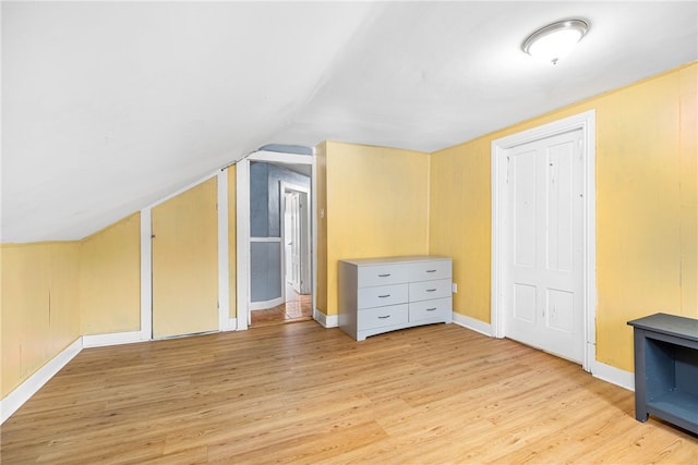 bonus room with lofted ceiling and light hardwood / wood-style flooring