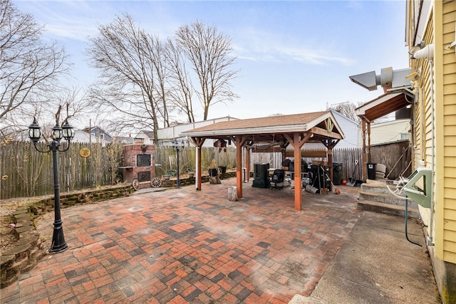 view of patio with a gazebo and a fireplace