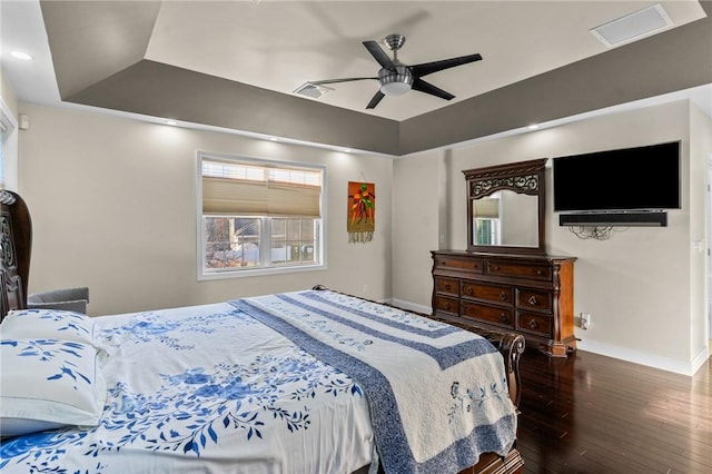 bedroom with a tray ceiling, ceiling fan, and hardwood / wood-style floors