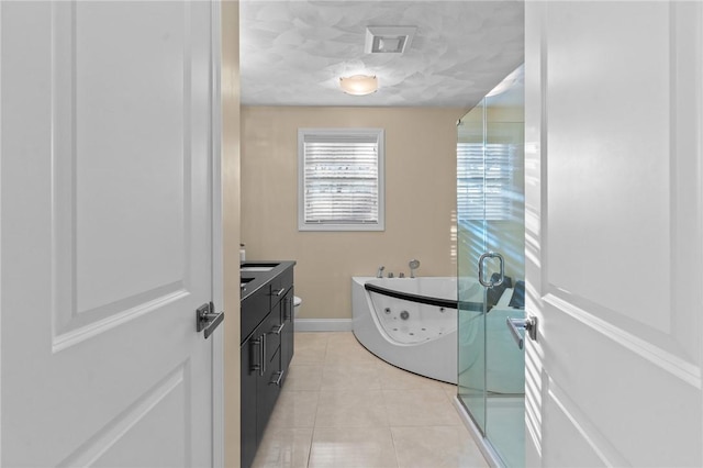 bathroom featuring tile patterned flooring, vanity, and a tub