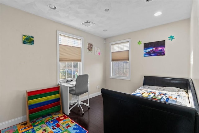 bedroom with dark hardwood / wood-style flooring