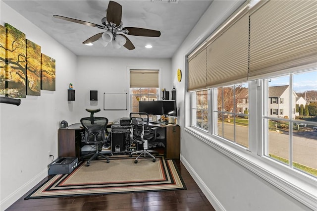 office space featuring ceiling fan, a healthy amount of sunlight, and dark hardwood / wood-style floors