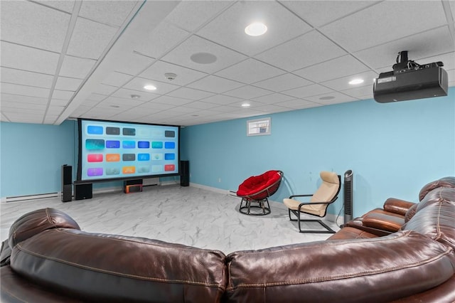 home theater featuring a paneled ceiling, carpet floors, and baseboard heating