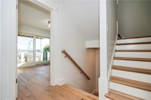 stairway with hardwood / wood-style flooring