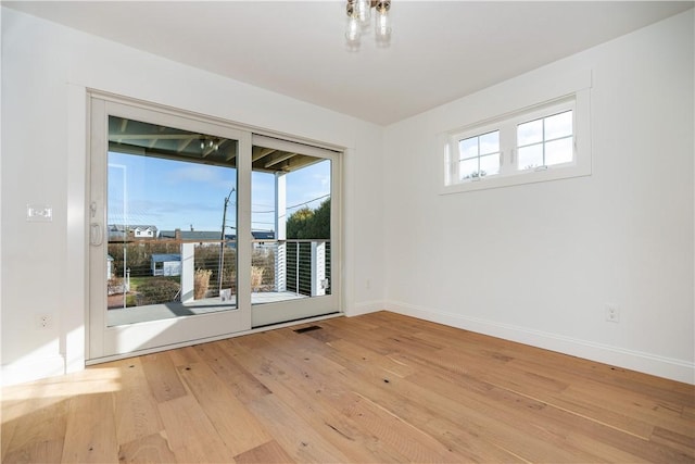 spare room featuring light wood-type flooring