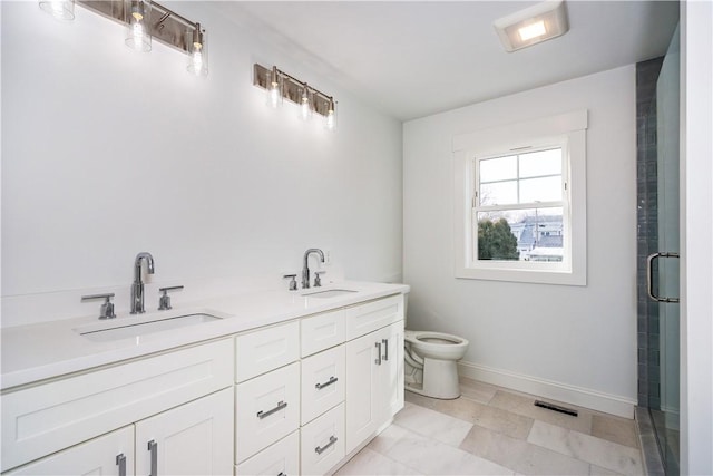 bathroom with a shower with door, vanity, and toilet