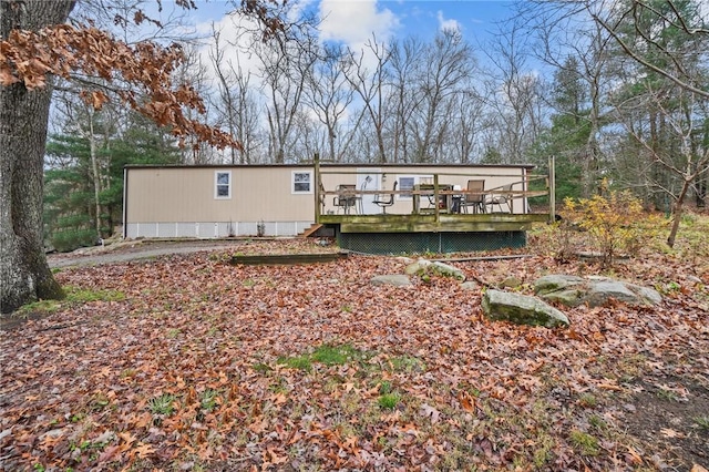 rear view of house featuring a deck