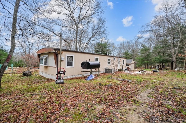 rear view of house with central AC