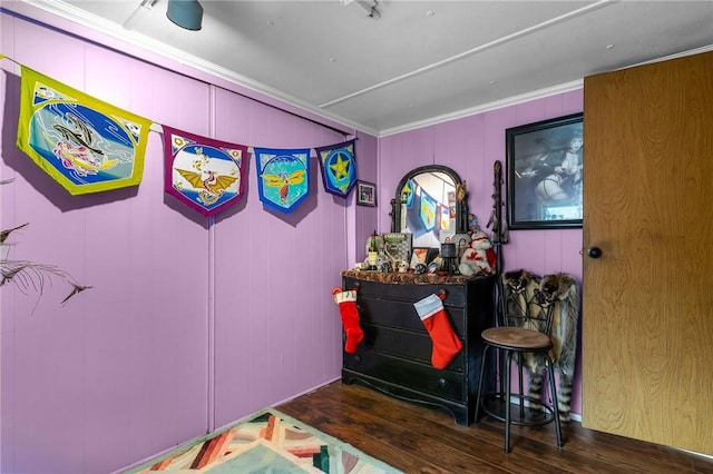 interior space with dark hardwood / wood-style floors and ornamental molding