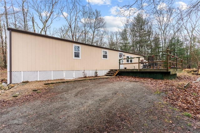 view of side of property featuring a wooden deck