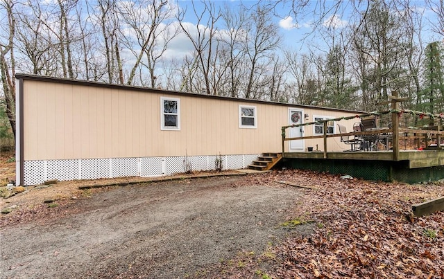 view of home's exterior featuring a wooden deck