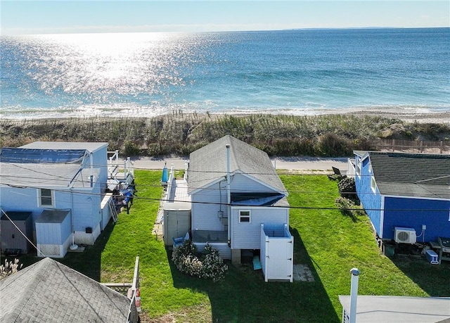 drone / aerial view with a water view and a beach view