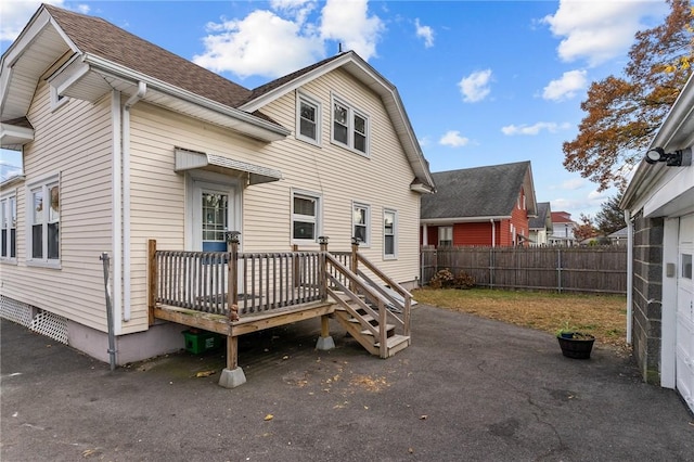 back of house featuring a deck