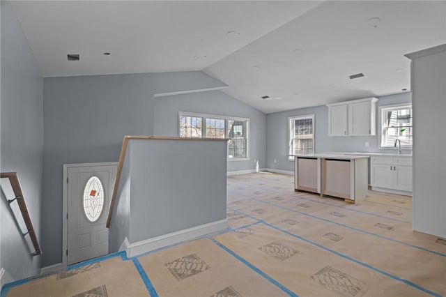 entryway with sink and vaulted ceiling