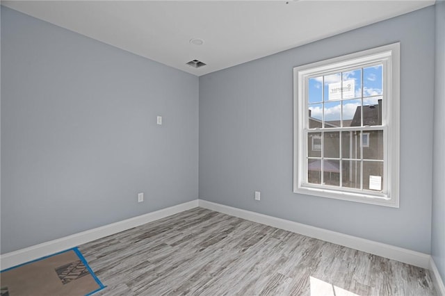 empty room with light hardwood / wood-style flooring