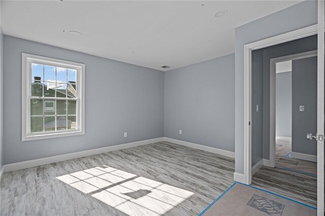 unfurnished room featuring light hardwood / wood-style floors