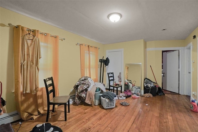 miscellaneous room with a baseboard radiator and light hardwood / wood-style flooring