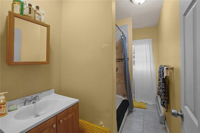 bathroom featuring tile patterned flooring, vanity, and tiled shower / bath